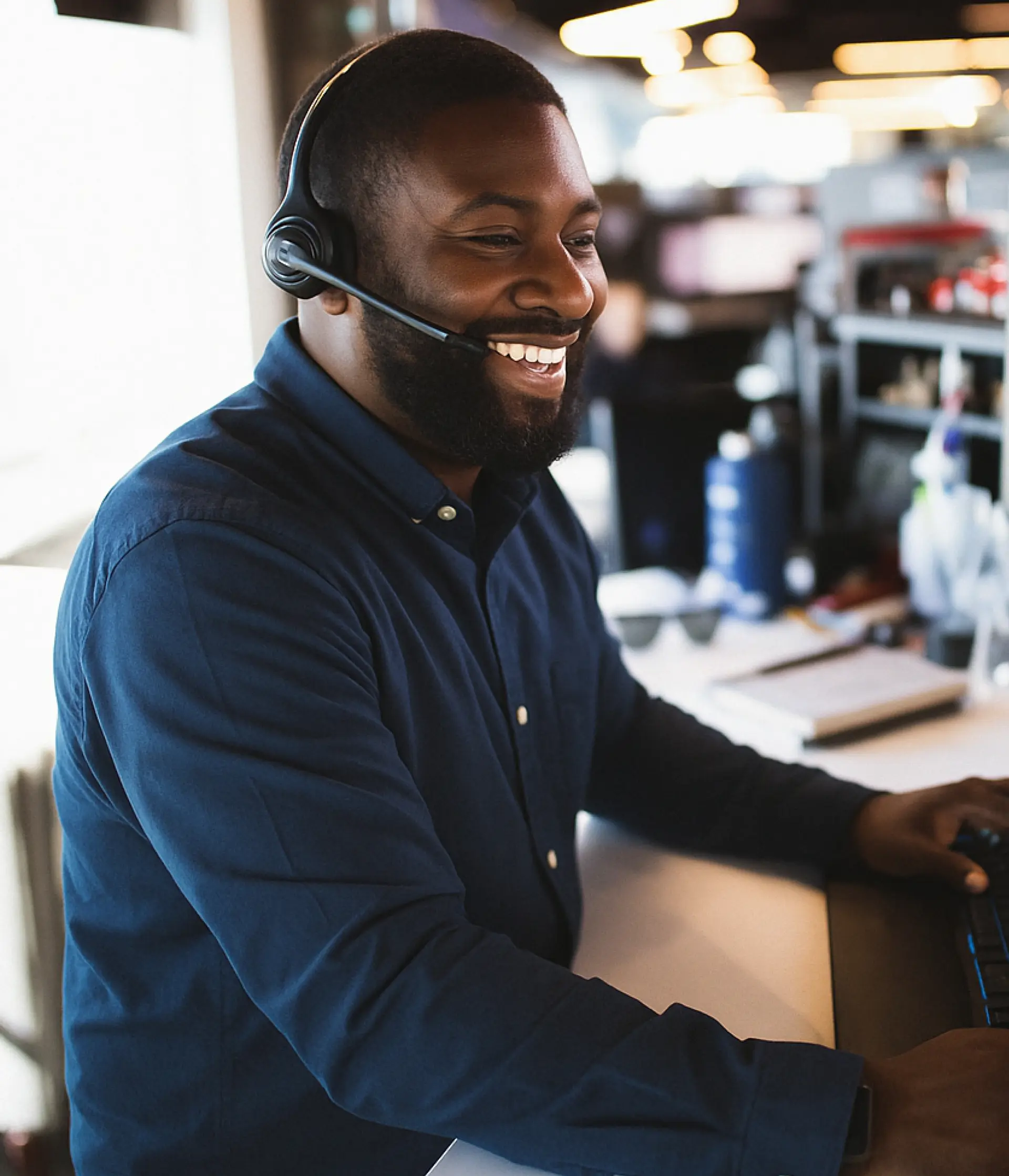 Person wearing headphones at desk