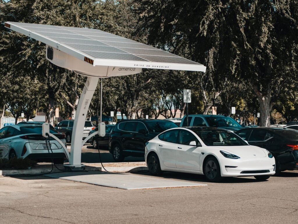 Electric vehicles charging under solar panels