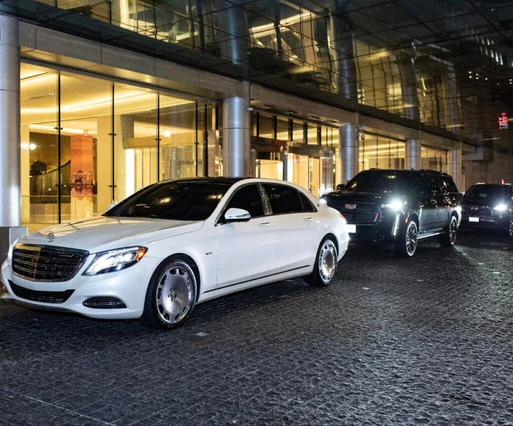 White Mercedes-Maybach and black Cadillac Escalade from the Elite Auto Vault chauffeur fleet